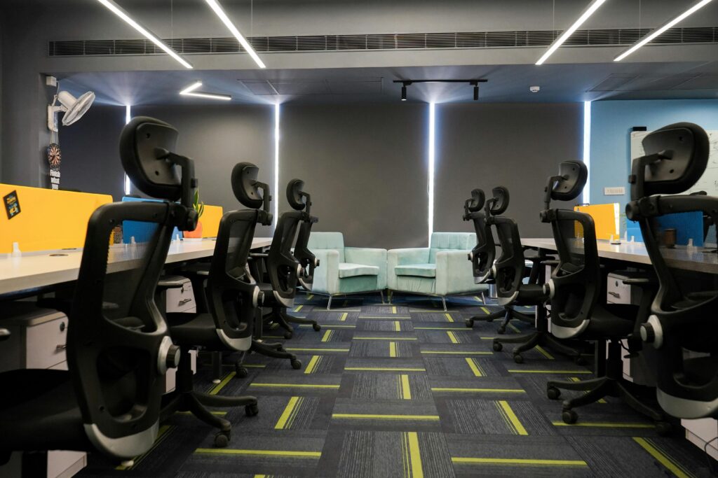 Spacious modern office with ergonomic chairs and bright decor, perfect for a productive work environment.